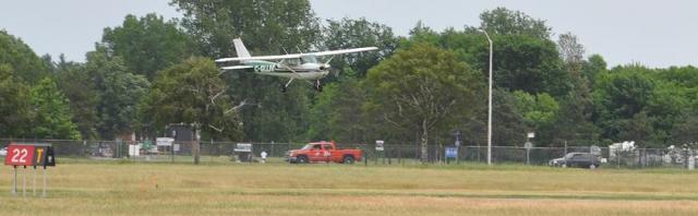 Brent Crooks and LLM on short final at the end of his first solo flight. 2010-06-02