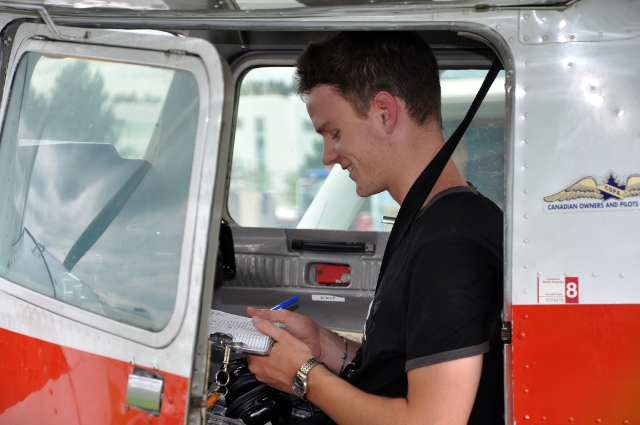 Happy: Patrick after his first solo, records the flight data on the Hobbs board.