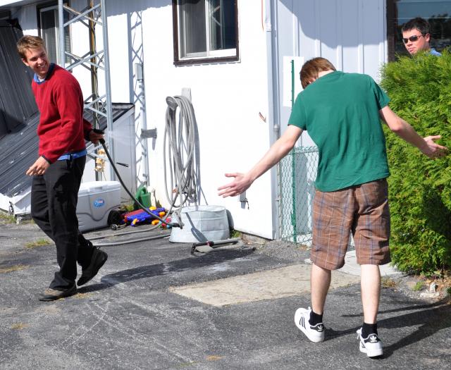 Getting Sprayed: Our Assistant CFI, Andrew Simpson, shows his behind-the-back style in celebrating Matthew's first solo.