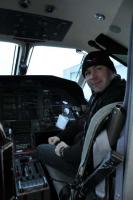 Ken Wright in the business end of the PC-12.: Ken, wearing his OFC gear, at the First Officer position of the PC-12.